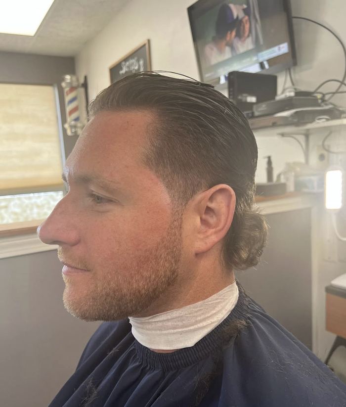 Slicked back haircut with fade